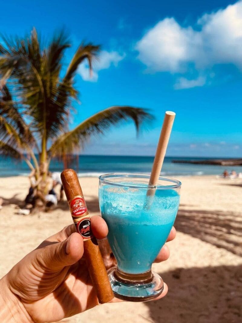 Aficionados enjoying cigars by the water